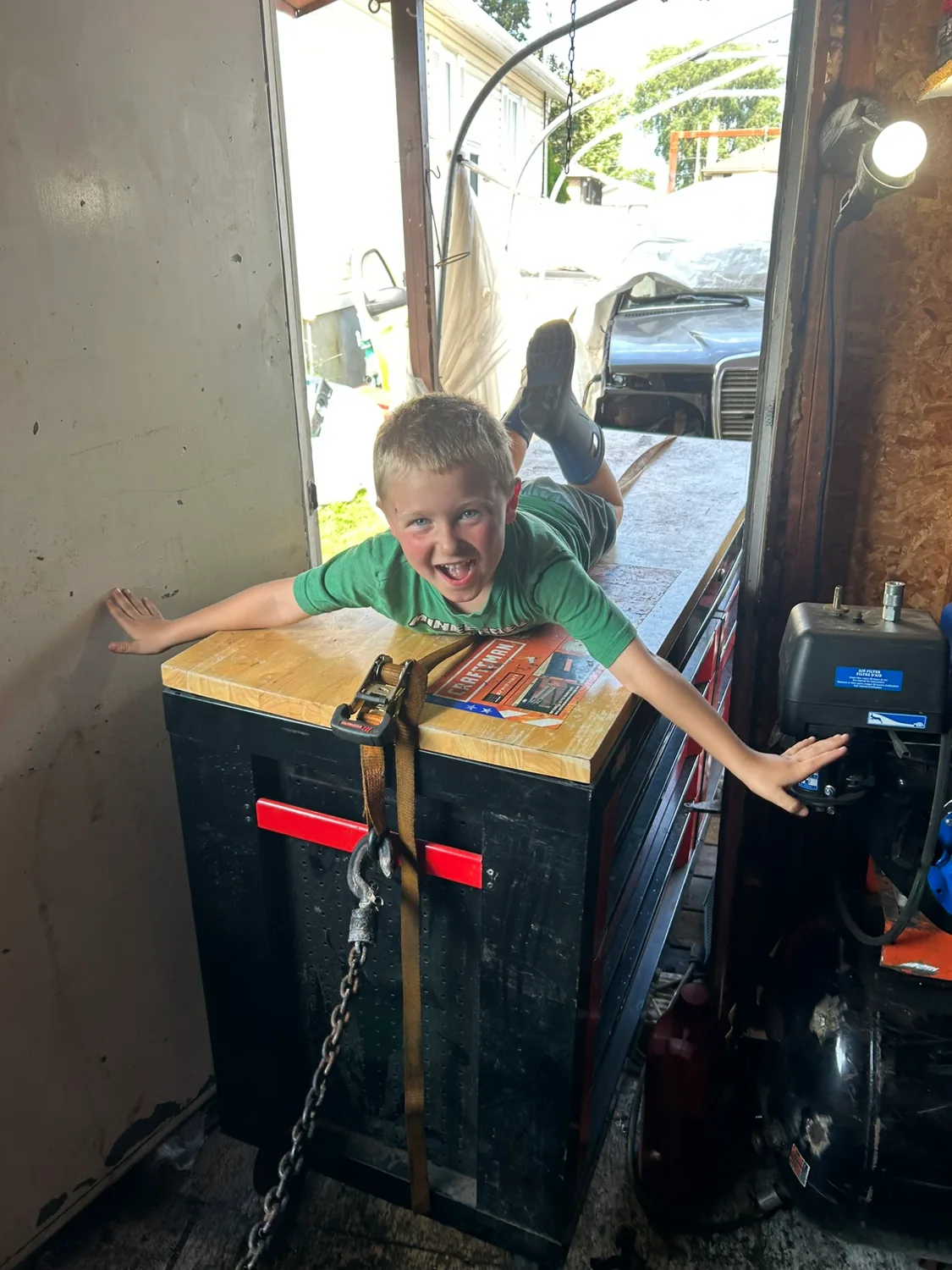 Elijah having fun on a workbench in the family workshop